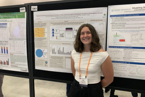 Female student in front of research poster